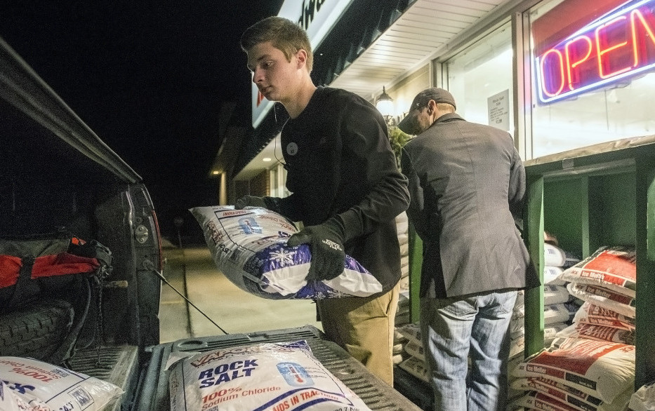 Oak Hill Hardware employee Jimmy Dugan helps Scarborough resident Nate Marcoux load rock salt into Marcoux's truck Wednesday in preparation for Thursday's storm.