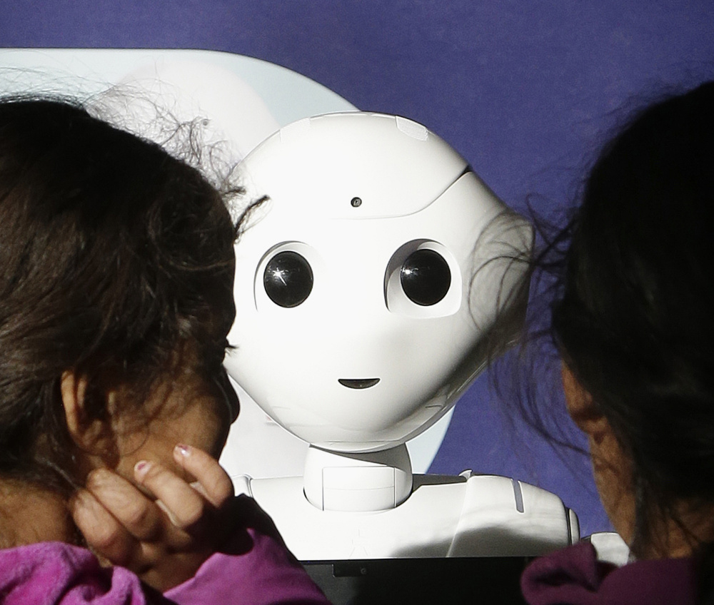 Children interact with Pepper, the 4-foot-tall robot that dances, poses for selfies and speaks in a cherubic voice, at Westfield Mall in San Francisco this month.