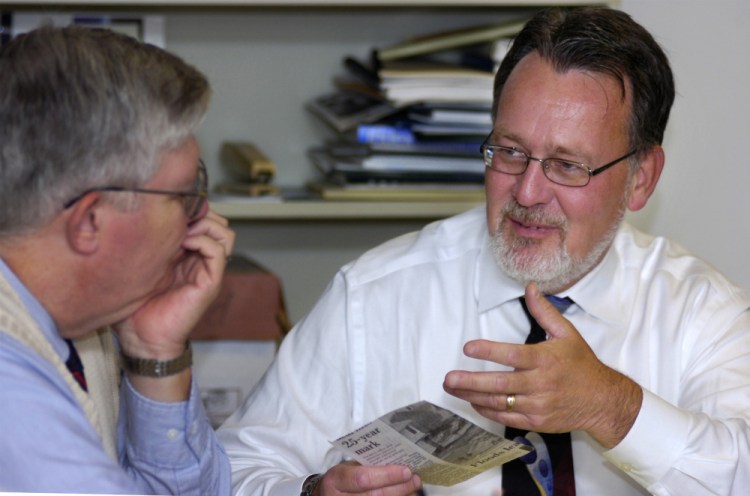 Charles Cochrane, then publisher of the Portland Press Herald, discusses topics for editorials with Mike Harmon, left, in 2005. Over a 41-year career, Harmon's various roles at the paper included city editor and editorial writer.