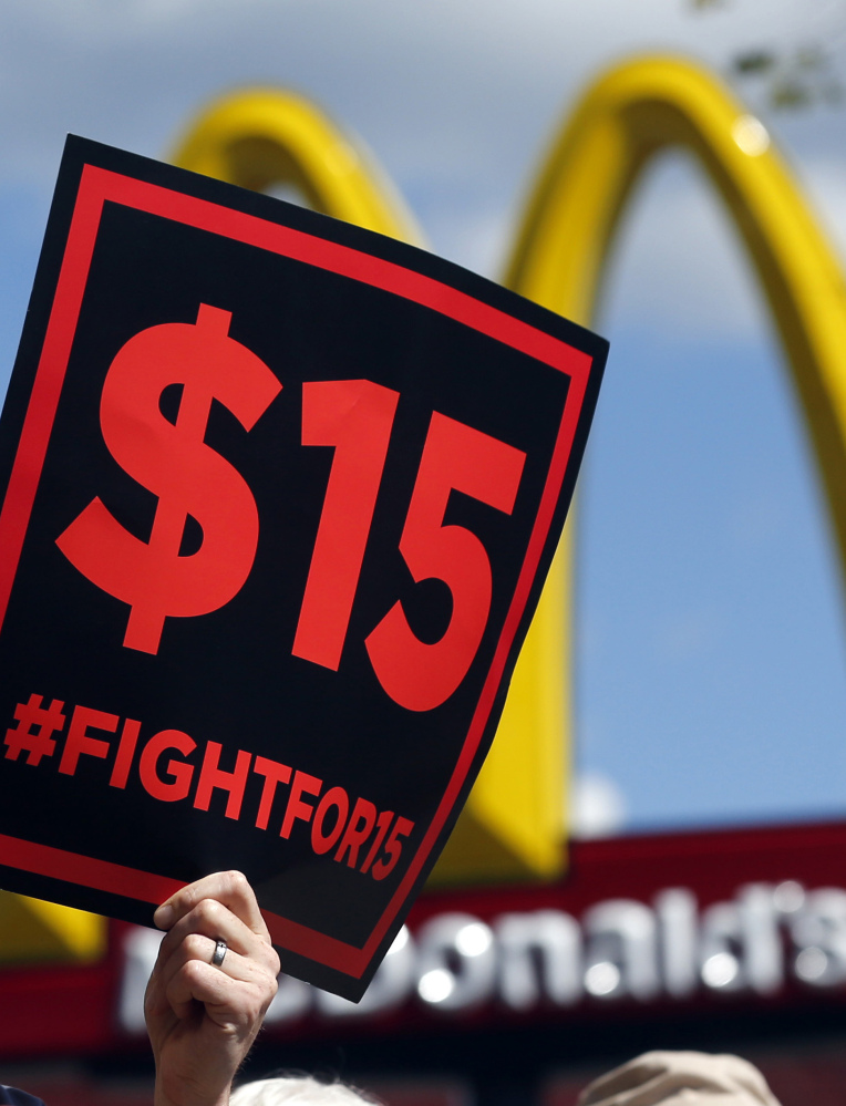 Supporters of a $15 minimum wage for fast-food workers rally in front of a McDonald's in Albany, N.Y., in 2015. The base wage is rising to $9.70 in upstate New York on Jan. 1.
