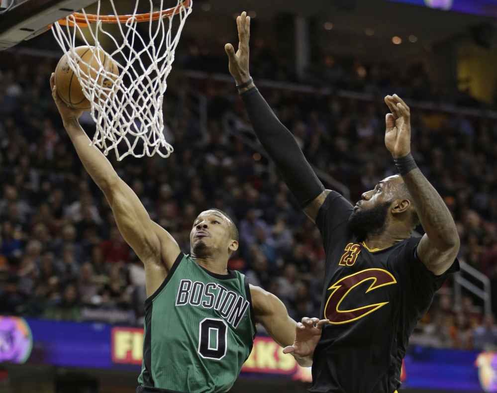 Boston's Avery Bradley drives to the basket against LeBron James in the first half Thursday in Cleveland.