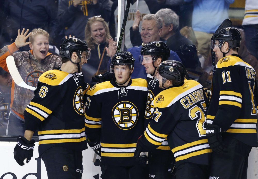 Boston's Tim Schaller, third from right, celebrates his goal with teammates Colin Miller (6), Torey Krug (47), Austin Czarnik (27) and Jimmy Hayes (11) during the second period Saturday's game against Buffalo in Boston. (Associated Press/Michael Dwyer)