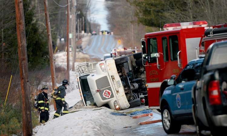 A truck lies on its side at the scene of an oil spill on Route 22 in Buxton on Tuesday.