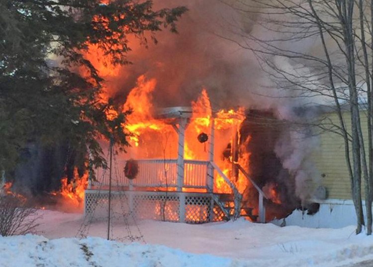 Fire engulfs a home on Blue Rock Road in Monmouth Tuesday morning. <em>Contributed photo courtesy of Kennebec Journal</em>