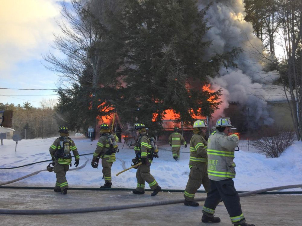 Firefighters work the scene at 15 Blue Rock Road in Monmouth Tuesday. <em>Contributed photo courtesy of Kennebec Journal</em>