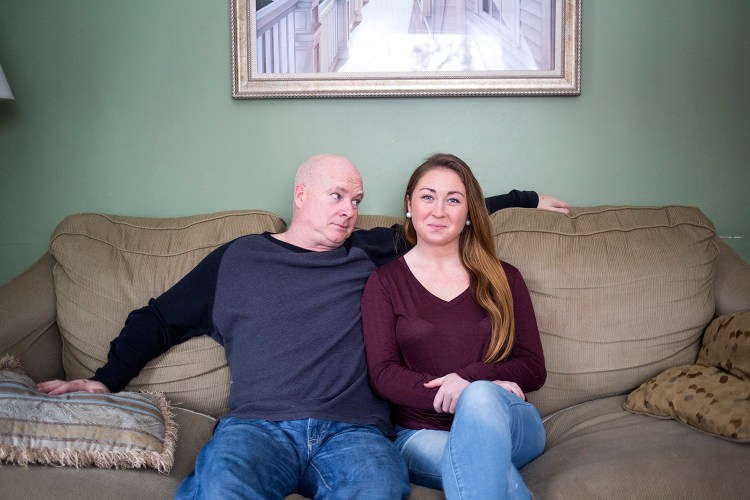 Dan Howard and his daughter, Shannon Howard, pose for a portrait in the living room of the family home in Cape Elizabeth. Shannon is spending almost a month at home during college winter break, and her father posted a humorous video of himself telling his Facebook friends about her return that ended up going viral. 