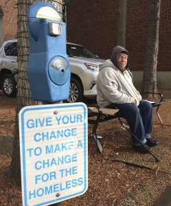Joe Drury, who says he is homeless, sits near a parking-style meter in Annapolis, Md., used to collect loose change from those who might otherwise give money to those begging on the street. Drury says the meters may help charities, but they do nothing for him. Associated Press/Pat Eaton-Robb