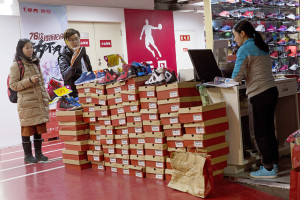 A man shops for shoes at a Qiaodan Sports retail shop in Beijing Thursday. Associated Press/Ng Han Guan