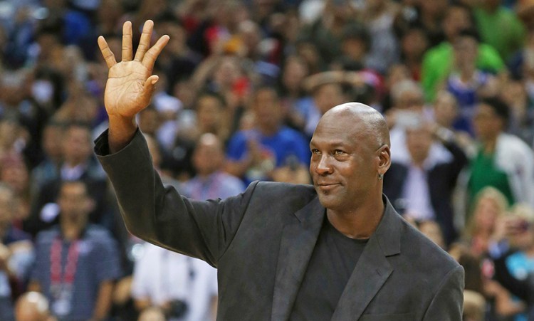 NBA legend Michael Jordan waves to fans at a Charlotte Hornets game in 2015. "Nothing is more important than protecting your own name, and today's decision shows the importance of that principle," Jordan said. in a statement. <em>Associated Press/Kin Cheung</em>