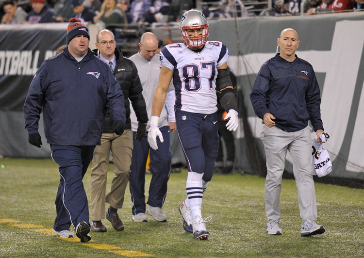 New England Patriots tight end Rob Gronkowski walks off the field after he was injured in the second quarter of Sunday's game against the New York Jets. <em>Associated Press/Bill Kostroun</em>