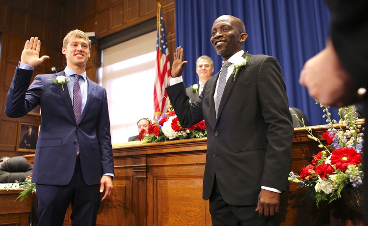 Newly elected Portland City Councilors Brian Battson, left, and Pious Ali are sworn in Monday at City Hall. <em>Ben McCanna/Staff Photographer</em>
