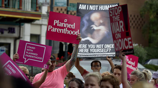 People participate in a rally to show support for Planned Parenthood in Kansas City, Mo., in 2015.    John Sleezer  /The Kansas City Star via AP
