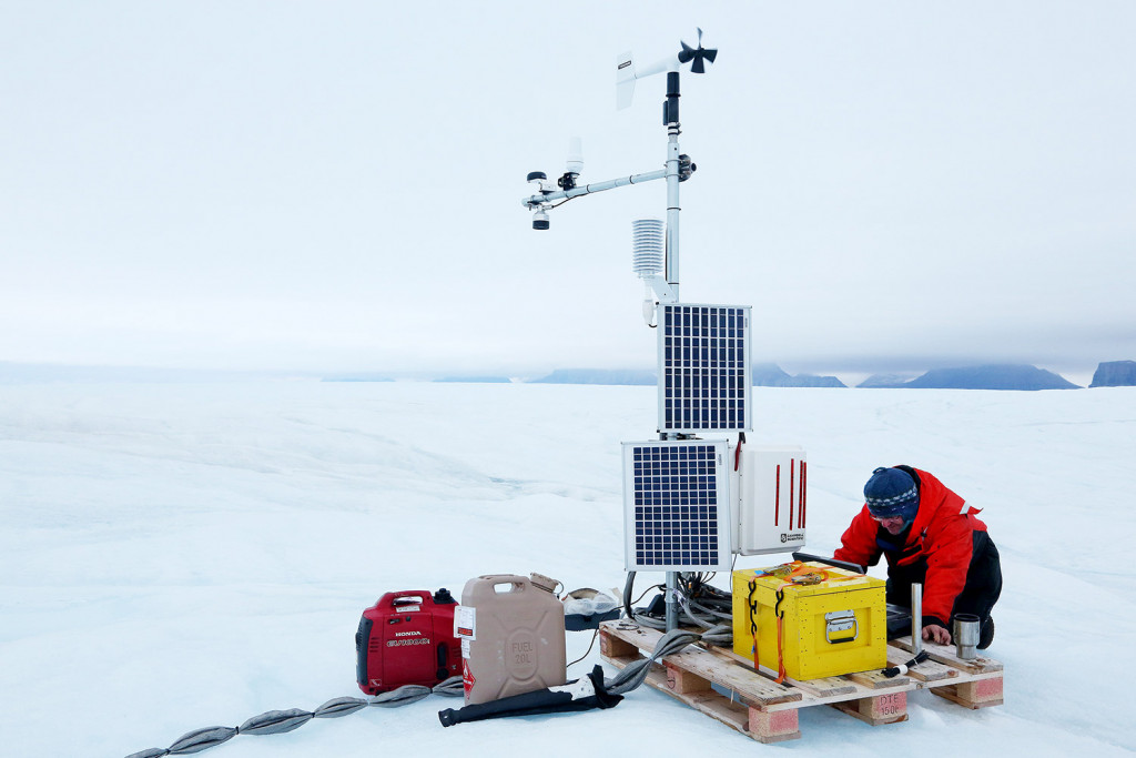 Andreas Muenchow finishes work on a weather station, which has a cable that runs deep into the ocean. 