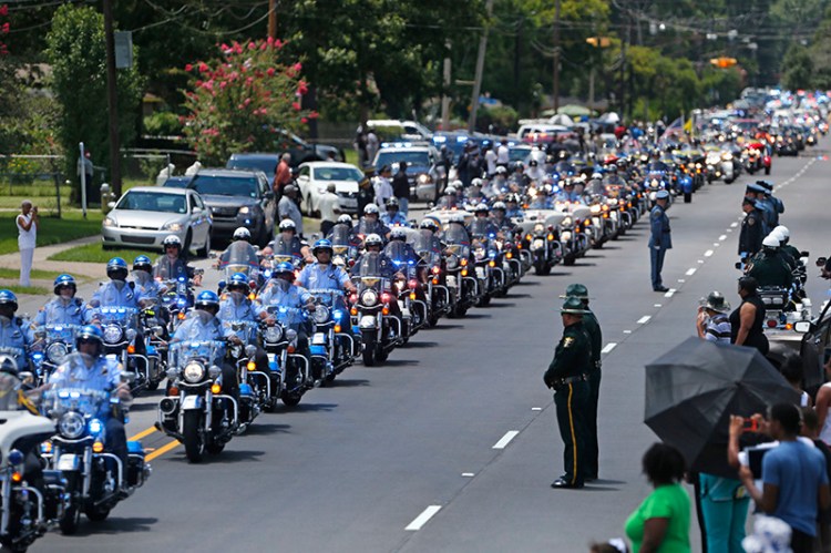The funeral procession for slain Baton Rouge police Corporal Montrell Jackson leaves in Baton Rouge, La. in July.  Jackson was slain by a gunman who authorities said targeted law enforcement.