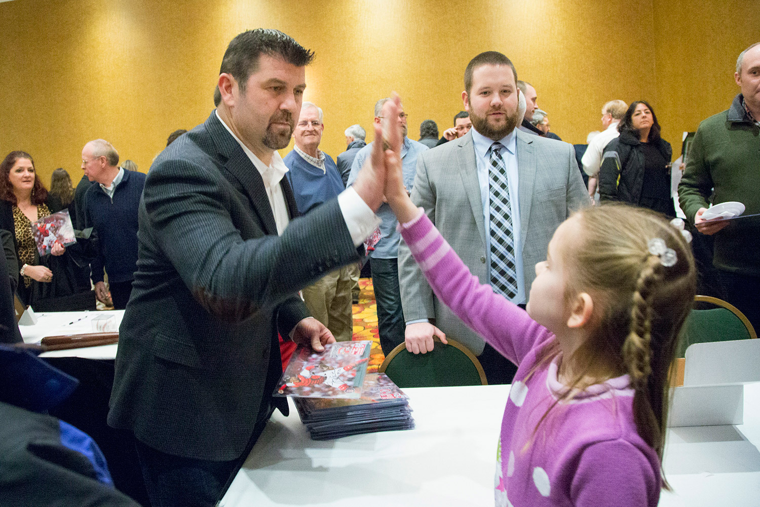 Jason Varitek, the catcher for Boston's 2004 and 2007 World Series championship teams, gives a high-five to Dominique Giroux-Pare, 8, of Winslow during the Portland Sea Dogs' annual Hot Stove Dinner on Friday night.