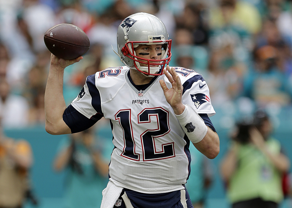 New England Patriots quarterback Tom Brady looks to pass during the first half against the Dolphins on Sunday in Miami Gardens, Fla.