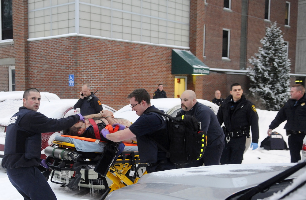 Firefighters and police escort Jason Begin after he was shot by police on Jan. 12, 2015.  Begin was shot when he began stabbing himself and threatened to hurt others after being told he was being returned to Riverview Psychiatric Center.