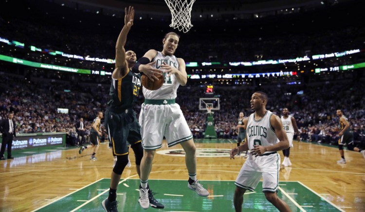 Boston Celtics center Kelly Olynyk grabs a rebound against Utah Jazz center Rudy Gobert  during the first quarter in Boston on Tuesday.
