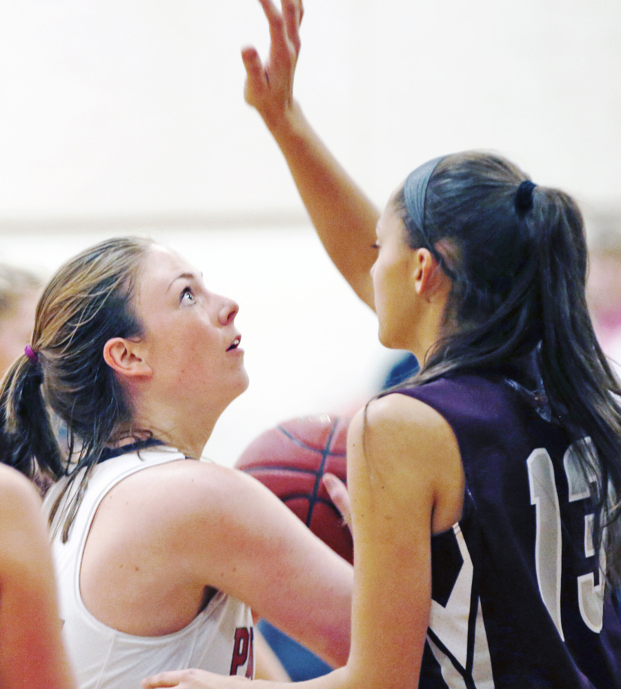 Skye Conley, who finished with 19 points and eight rebounds for Gray-New Gloucester, looks for a shot while guarded by Megan Cormier of Freeport.