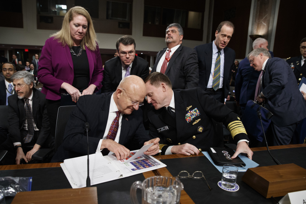 Director of National Intelligence James Clapper, left, talks with National Security Agency and Cyber Command chief Adm. Michael Rogers on Capitol Hill in Washington on Thursday at the conclusion of a Senate Armed Services Committee hearing on foreign cyber threats.