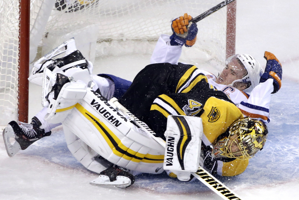 Oilers center Connor McDavid crashes into Bruins goalie Tuukka Rask in the first period Thursday night in Boston.