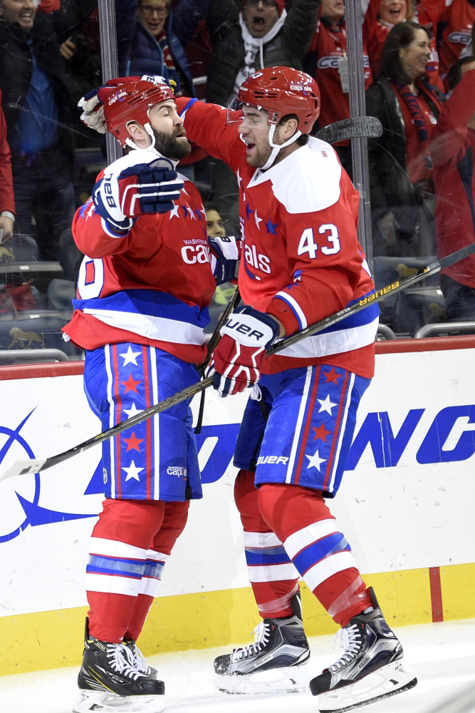 Capitals left wing Daniel Winnik, left, celebrates his first-period goal with teammate Tom Wilson on Thursday night in Washington. Winnik's goal set the Capitals on the way to a 5-0 win over division-leading Columbus.