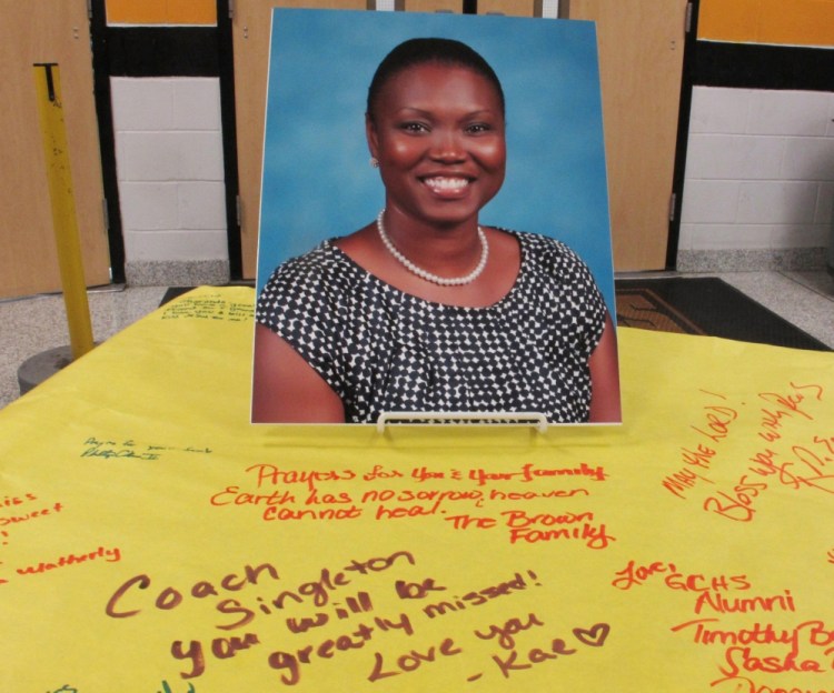 A picture of Sharonda Coleman-Singleton, a school speech pathologist and girls' track coach, sits on a large paper signed by students, teachers and friends in Goose Creek, S.C., in June 2015. She was one of the nine people killed by Dylan Roof at Emanuel AME Church.