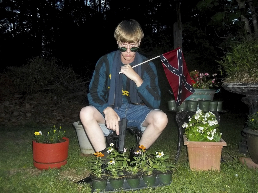 This undated photo that appeared on Lastrhodesian.com, a website investigated by the FBI in connection with Dylann Roof, shows him posing for a photo holding a Confederate flag. Roof faces life in prison or execution for gunning down nine black church members in a racially motivated attack in 2015.