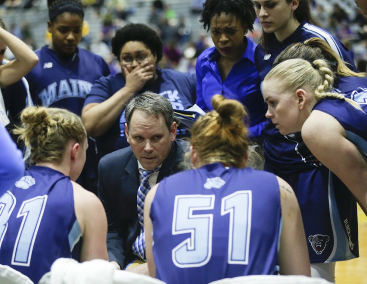 Maine head coach Richard Barron, center, talks to his players during a timeout during the second half an America East game against Albany in the America East Conference tournament championship in March 2016. (AP Photo/Mike Groll)