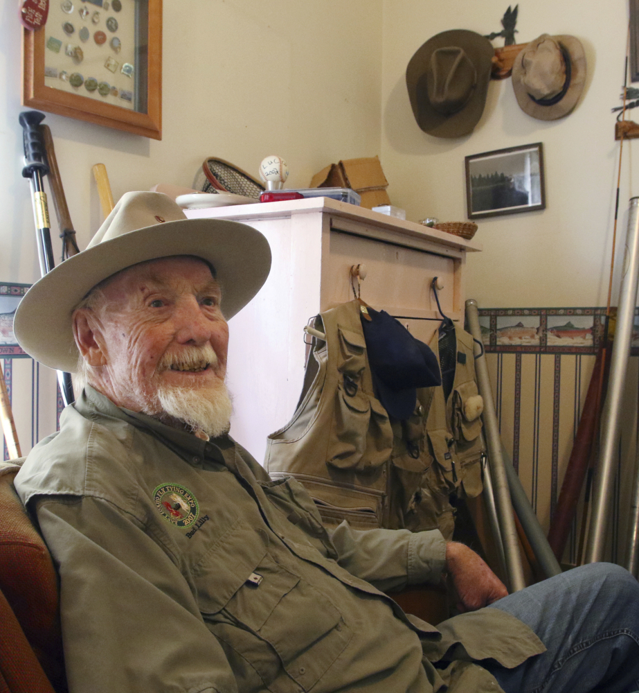 Bud Lilly sits in his house in Three Forks, Mont., surrounded by mementos of a fly-fishing life.