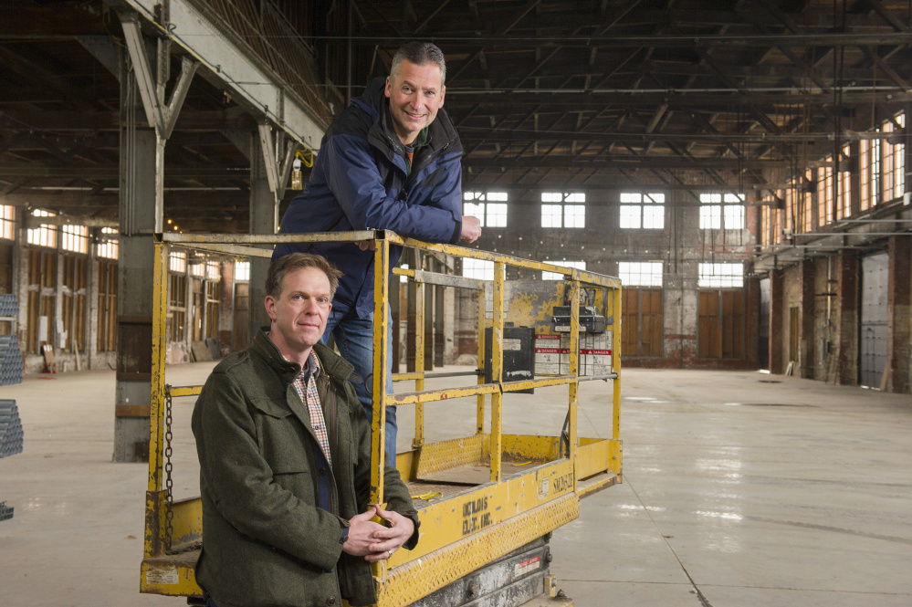 Chris Thompson, front, and his partner, Jed Troubh, are developing the 27,000-square-foot Brick South Event Center at Thompson’s Point in Portland.