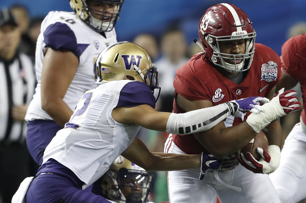 Alabama defensive lineman Jonathan Allen, right, returning a fumble against Washington in the national semifinals, earned a degree in financial planning, returning to school for his senior season to get it.