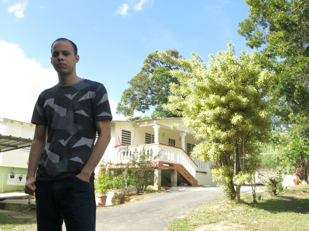 Bryan Santiago stands in front of the family home Saturday in Penuelas, Puerto Rico. "The FBI failed there. ... We're not talking about someone who emerged from anonymity to do something like this," he said about his brother Esteban Santiago, who is accused of killing five people at a Florida airport Friday.