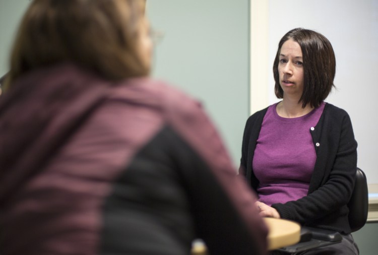 Addiction specialist Dr. Kristen Silvia, right, consults in Scarborough with a patient to whom she prescribes Suboxone. "Our biggest hurdle is the uninsured," she said.