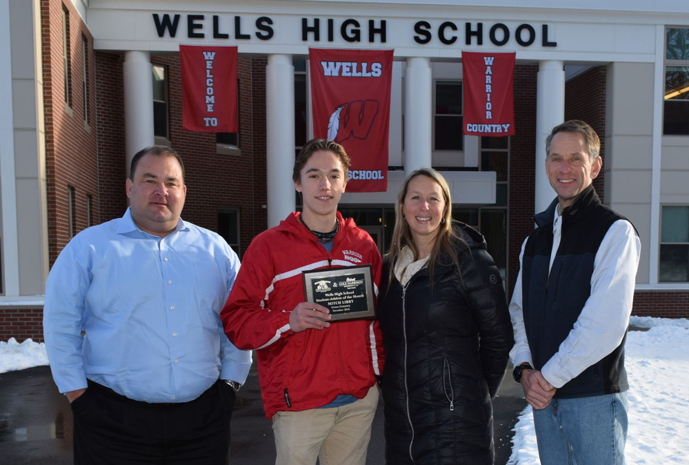 Wells High junior Mitch Libby receives the school's Student-Athlete of the Month Award from sponsors John C. Kreie of Cole Harrison Insurance, left, Pamela Moody-Maxon of MoodyMaxon Real Estate and cross country coach Bob Winn.