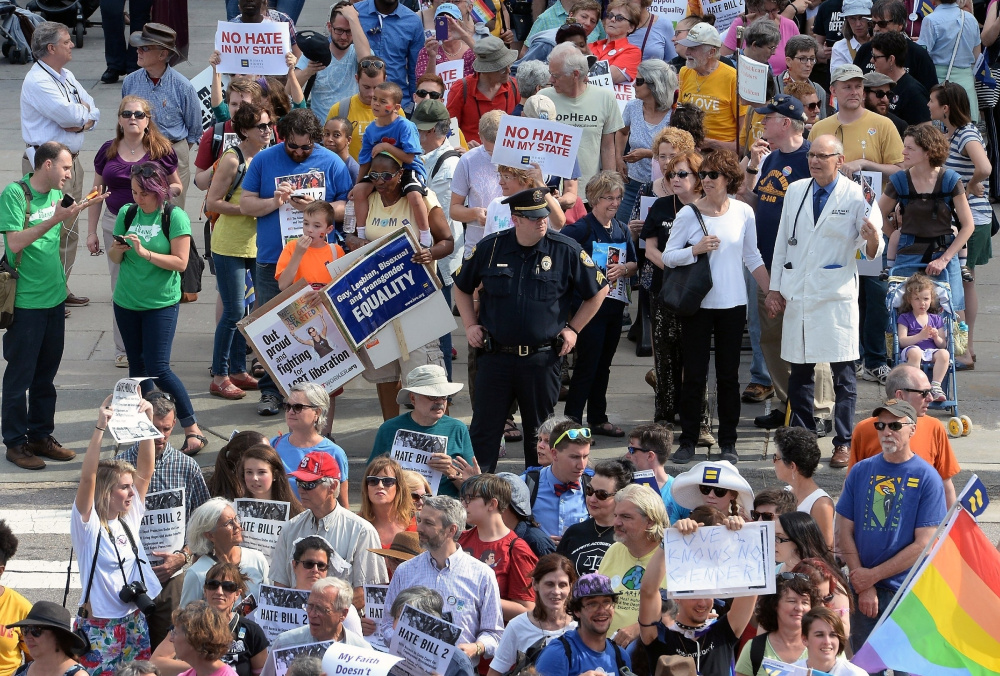Protesters head to the legislative building in Raleigh, N.C., for a sit-in against a law that would limit protections for LGBT people. The Trump administration may bring more challenges for LGBT activists.