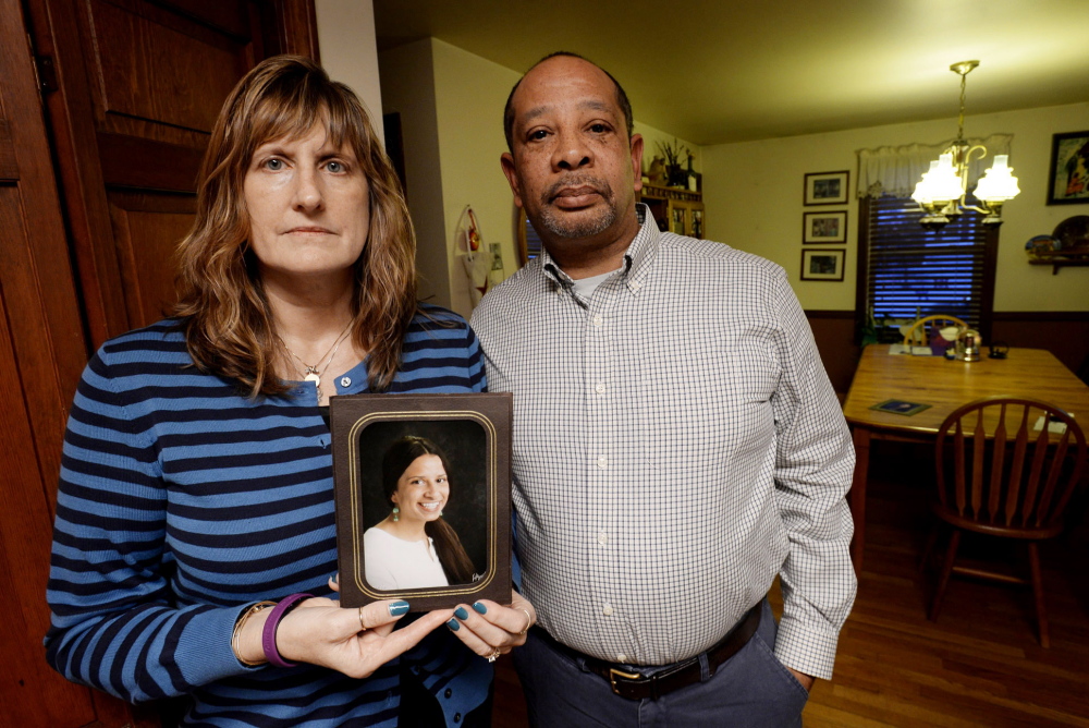 Judith and Wayne Richardson, the parents of Darien Richardson, whose killing in 2010 remains unsolved, hold a photograph of her in 2014.