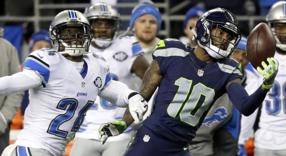 Paul Richardson makes a one-handed catch against Lions cornerback Nevin Lawson during Seattle's 26-6 win in an NFC playoff game Saturday night.