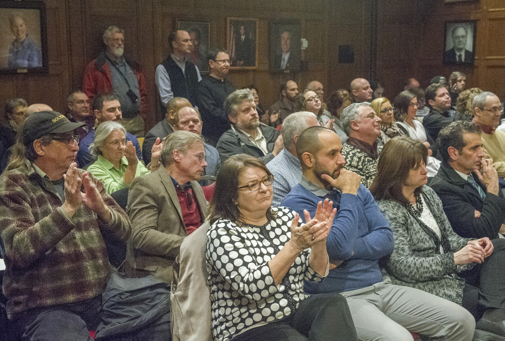 Audience members have a mixed response to a point made by Mayor Ethan Strimling during his address in council chambers.
