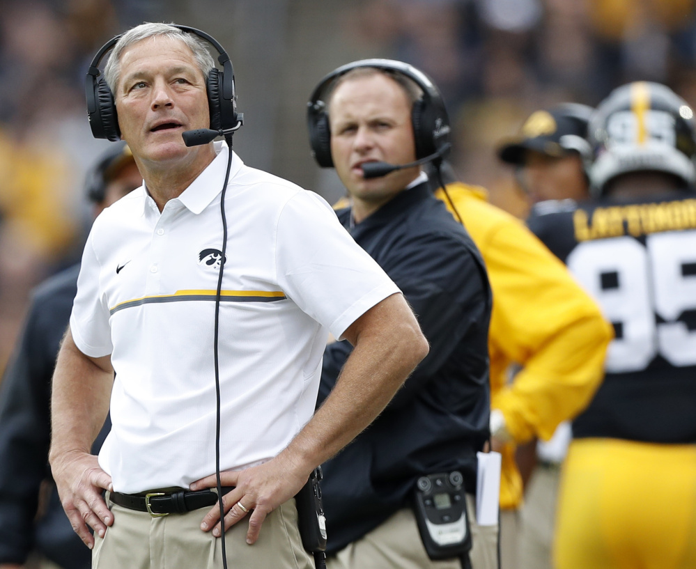 Iowa Coach Kirk Ferentz, left, who coached at UMaine from 1990 to 1992, hired his son, Brian, 33, to replace the retiring Greg Davis as the team's offensive coordinator.