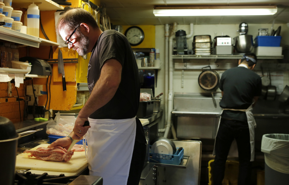 Chef Evan Mallett prepares rabbit for dinner in the kitchen of his Portsmouth, N.H., restaurant, the Black Trumpet. "I'm pretty adamant about sourcing from within New England, and from New Hampshire and Maine whenever possible," he says.