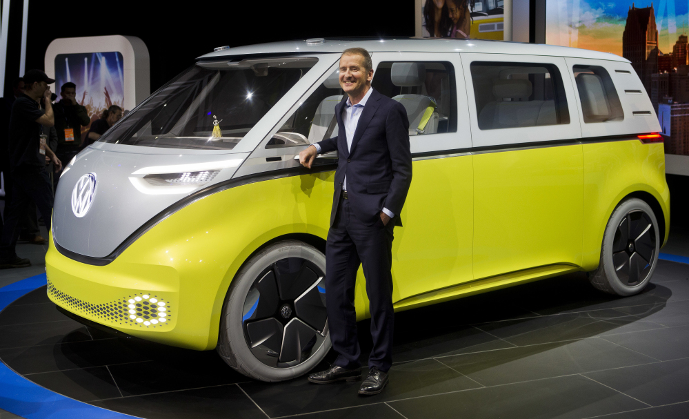 Herbert Diess, chairman of Volkswagen, poses with the I.D. Buzz all-electric concept van at the North American International Auto Show on Monday in Detroit. Booming business in China helped VW increase its sales to 10.31 million vehicles last year.
