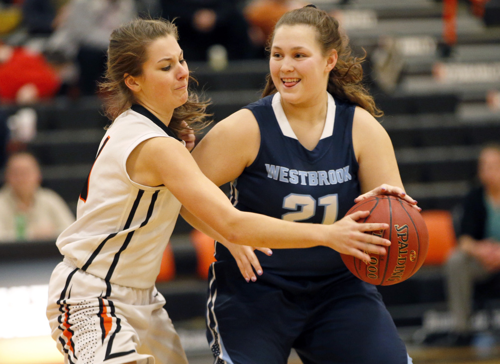 Hailey Allen of Biddeford attempts to knock the ball away from Julia Symbol of Westbrook during their SMAA girls' basketball game Tuesday night. Symbol scored 19 points as Westbrook came away with a 50-41 victory.