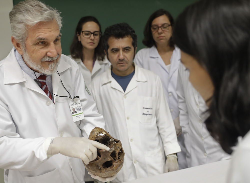 Dr. Daniel Munoz, head of the Department of Legal Medicine at the University of Sao Paulo's Medical School, shows students the skull of Nazi war criminal Josef Mengele.