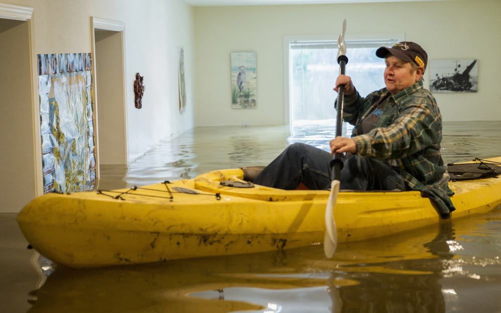 Lorin Doeleman checks her home Wednesday in Guerneville, Calif. Parts of northern California saw the heaviest rain in a decade.