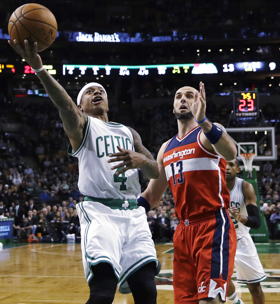 Celtics guard Isaiah Thomas drives to the basket past Washington center Marcin Gortat in the first quarter Wednesday night in Boston.