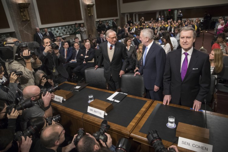 Defense Secretary-designate James Mattis, center, flanked by former Georgia Sen. Sam Nunn, left, and former Maine Sen. and former Defense Secretary William Cohen, arrives on Capitol Hill in Washington on Thursday to testify at his confirmation hearing before the Senate Armed Services Committee.
