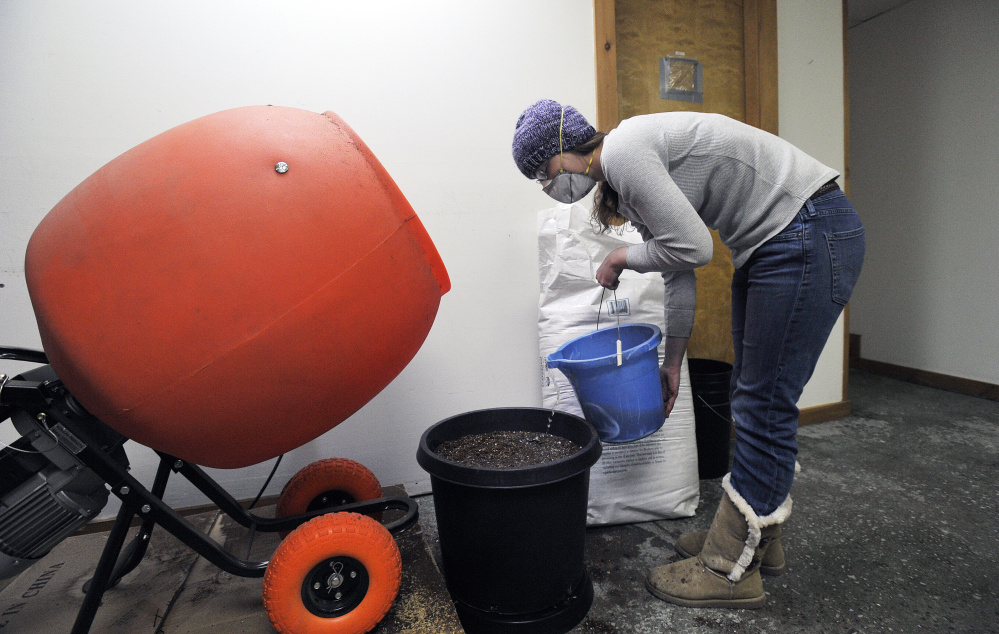At East Coast CBDs in Unity, Billie Pirruccello adds water to soil she just mixed. East Coast CBDs also uses high-efficiency heat pumps and forgoes chemical fertilizers in an effort to boost sustainability.