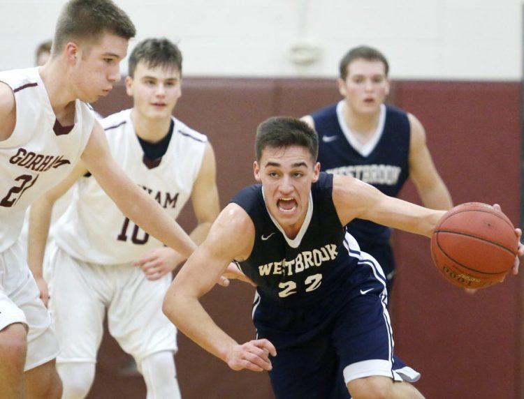 Zac Manoogian of Westbrook keeps the ball away from Kyle King of Gorham while heading up the court following a steal in the second quarter.