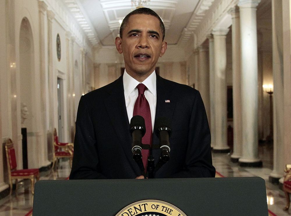 In this May 1, 2011, file photo, President Obama reads his statement to photographers after making a televised statement on the death of Osama bin Laden from the East Room of the White House in Washington. More than half of Americans view Obama favorably as he leaves office, a new poll shows, but Americans remain deeply divided over his legacy. Less than half of Americans say they're better off eight years after his election or that Obama brought the country together. (Associated Press/Pablo Martinez Monsivais)